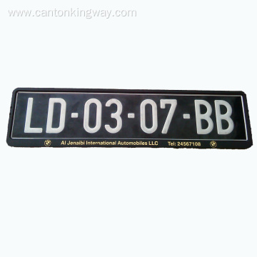 Number plate holder with embossed chrome logo
